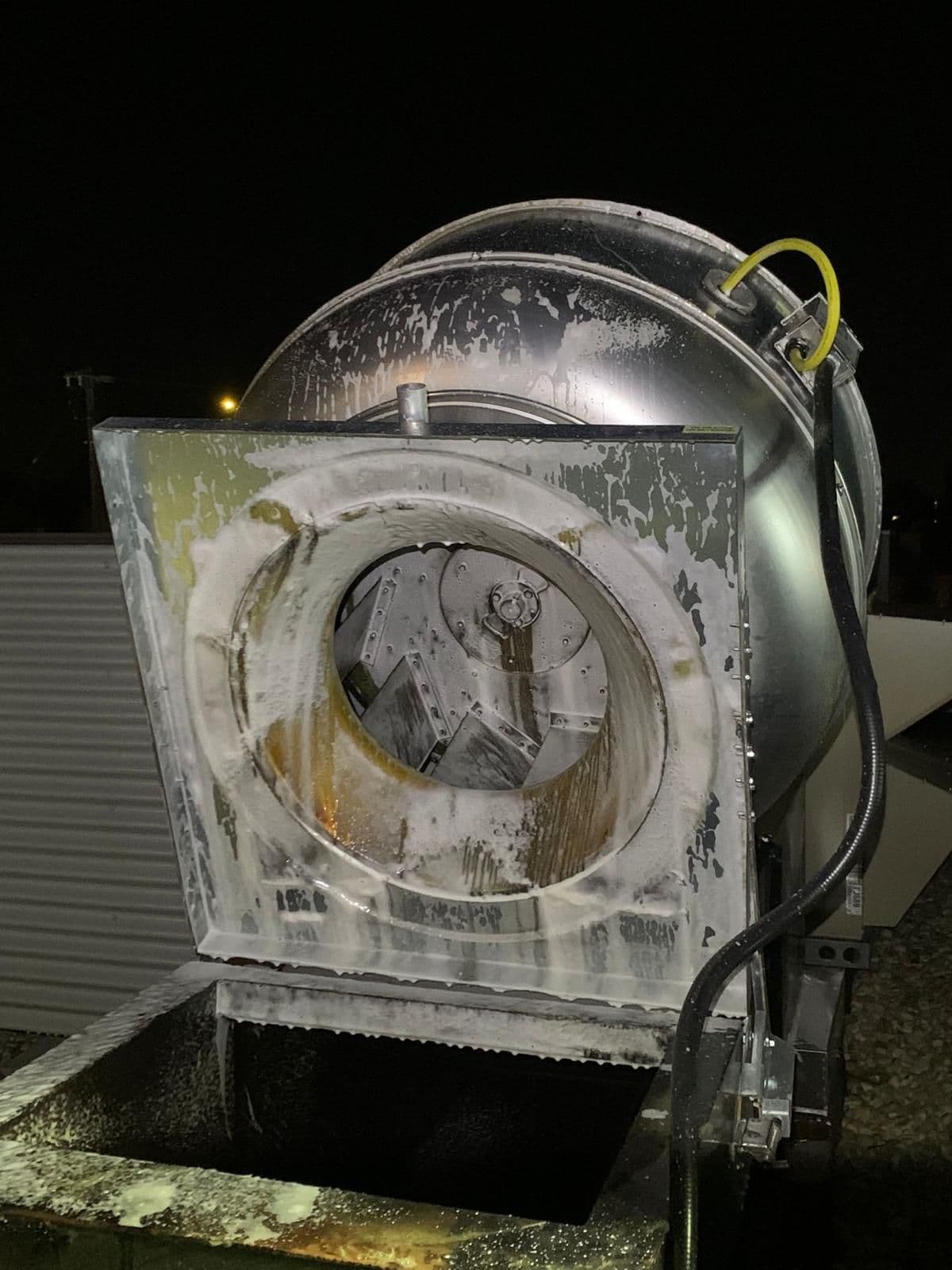 Technician cleaning fan in Edmonton
